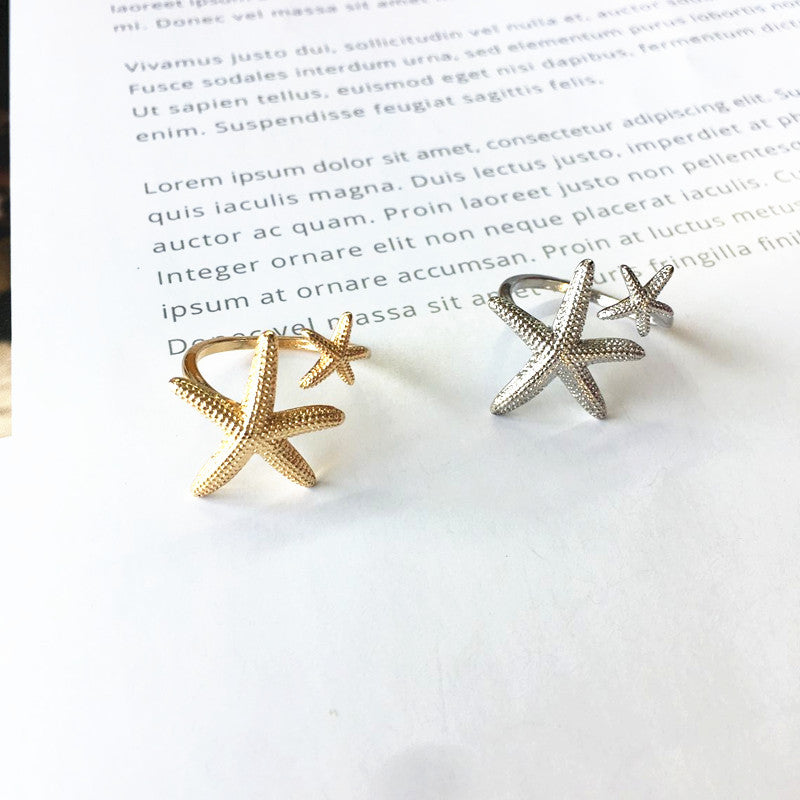 Anillo ajustable estrella de mar en plata y oro