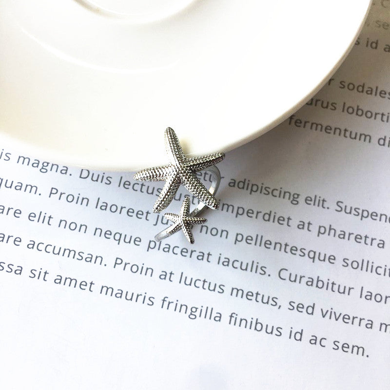 Anillo ajustable estrella de mar en plata y oro