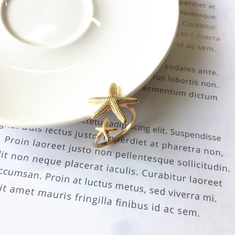 Anillo ajustable estrella de mar en plata y oro