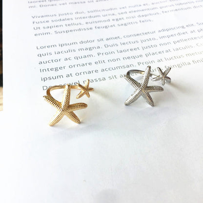 Anillo ajustable estrella de mar en plata y oro
